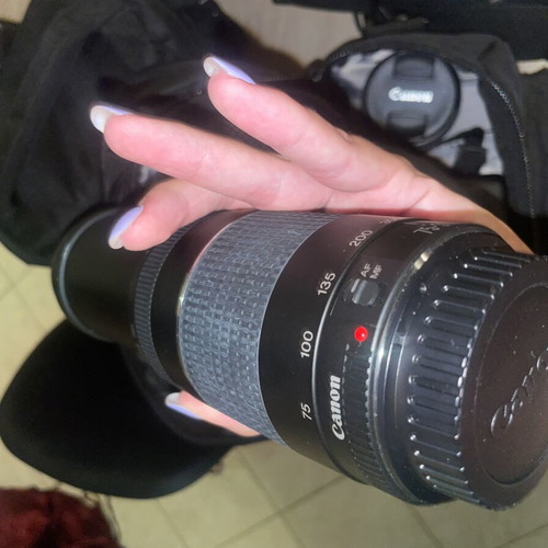 Canon EOS 1200D camera kit with lenses, memory card, battery, charger, and carrying bag