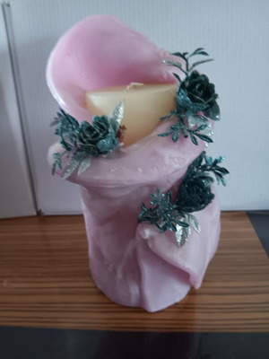 Decorative candle used with decorative flowers and slight damage