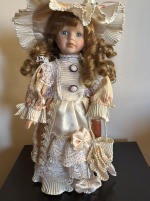 Porcelain doll with vintage clothes new, collectible