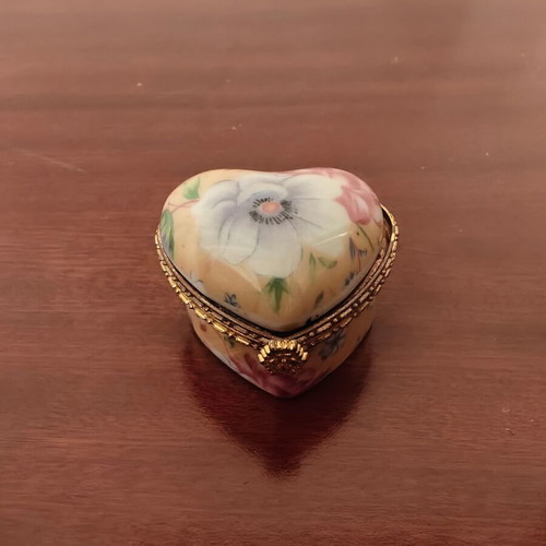 Decorative heart-shaped box used, broken with rust