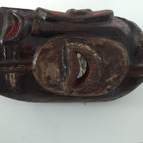 Handmade wooden mask used with aged patina