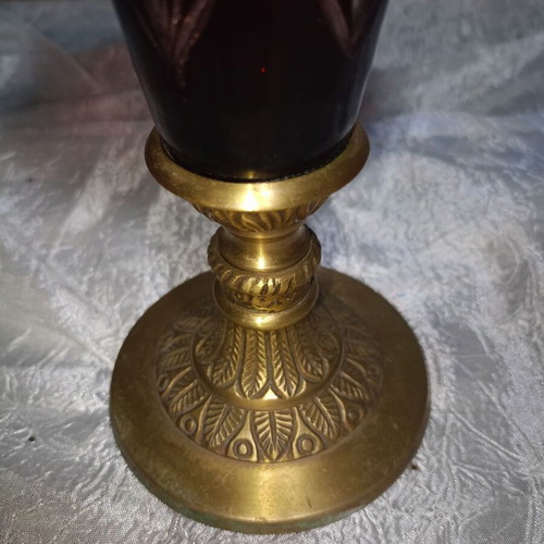 Vintage red glass vase with cut designs and decorative brass base and rim