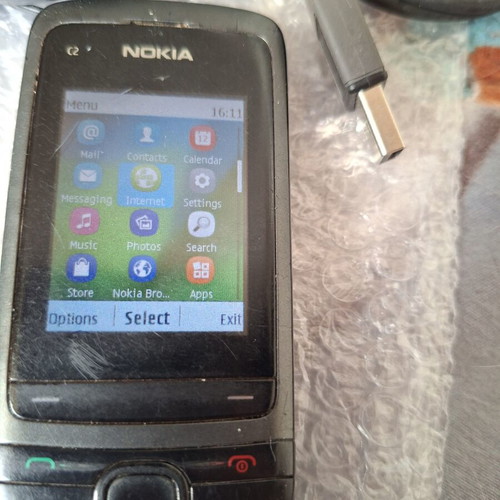 Nokia C2-05 phone with charger, headphones and data cable