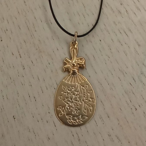 Handmade metal pendant with silver clasp and synthetic silk cord like new
