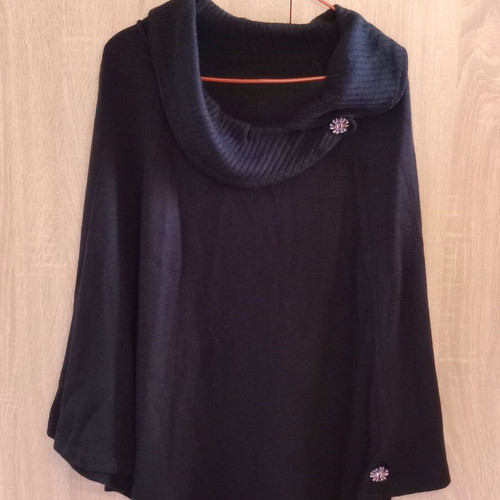 Black poncho like new, one size with details on sleeves and neck