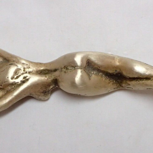 Vintage brass bottle opener shaped like a woman used