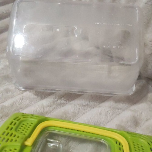 Plastic aquarium used with orange and blue gravel and accessories