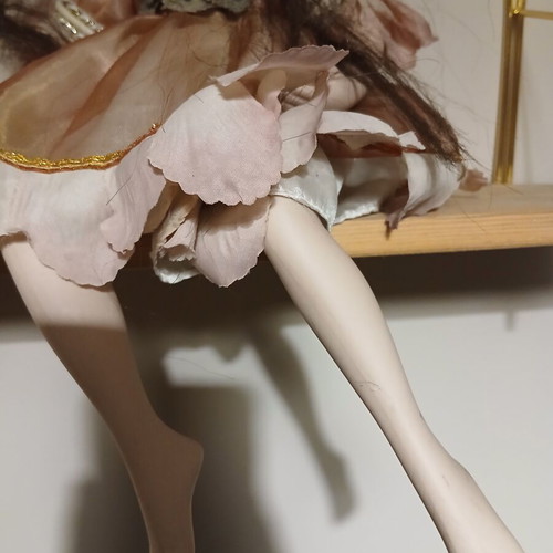 Porcelain doll sitting pose