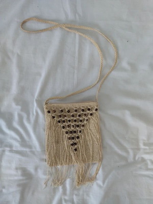 Cream knitted shoulder bag with fringes and wooden beads used