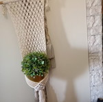 Two knitted wall hangers for pots, different sizes