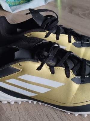 Adidas Messi football shoes, black and gold