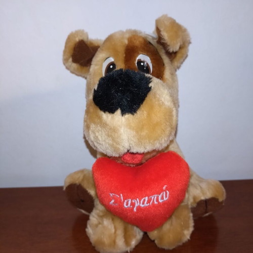 Plush dog used with red heart