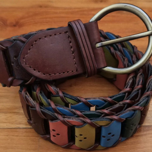 Colorful woven belt in warm shades made of faux leather, like new