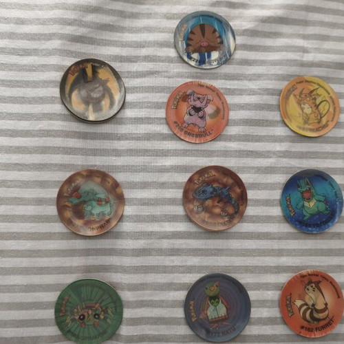 Pokemon Tazos used with visible wear