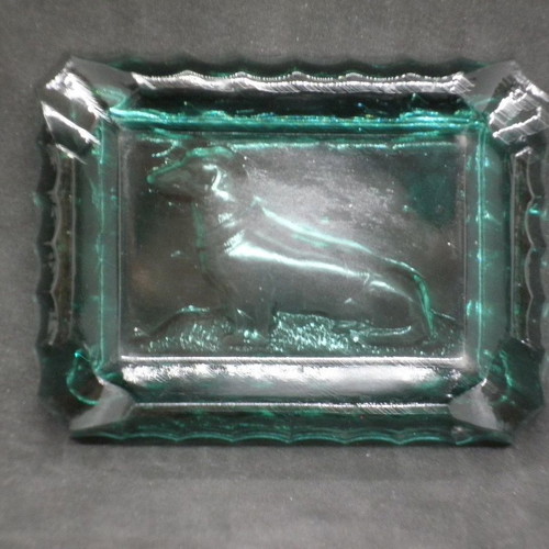 Antique ashtrays pair used with embossed dogs in dark green glass