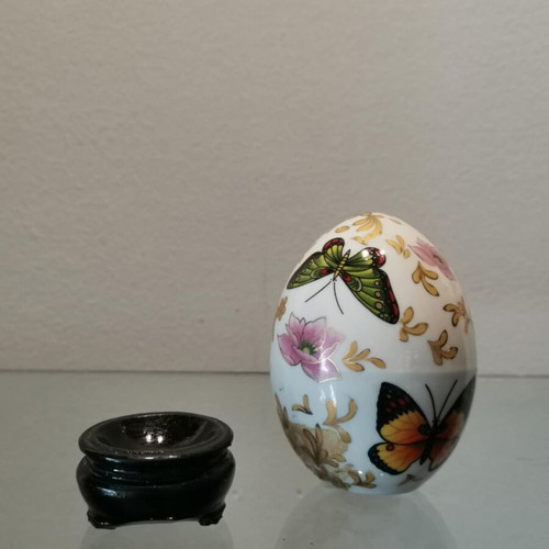 Porcelain egg used with butterflies and wooden base