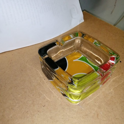 Glass ashtray with colorful bottom like new