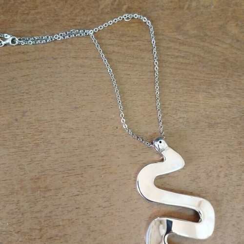 Silver necklace with wave-shaped snake pendant like new