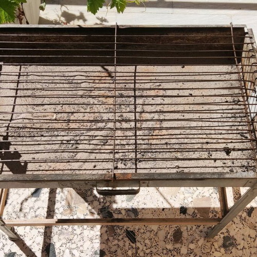 Galvanized small charcoal grill used with skewer supports