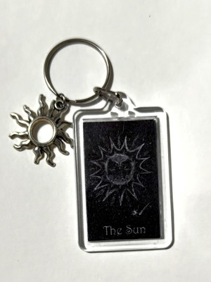 The Sun keychain hand-painted drawing, like new, black and silver