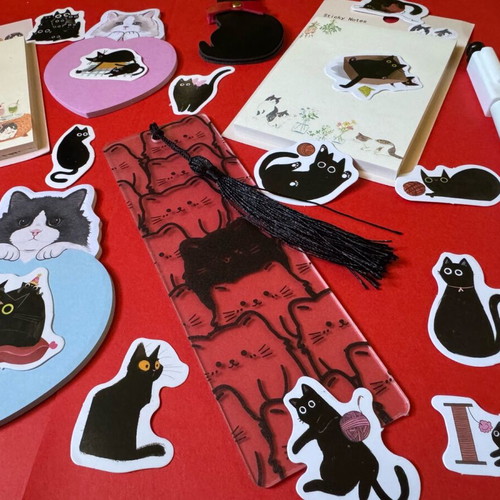 Cat-themed stationery set like new with sticky notes, pens, bookmarks, and stickers