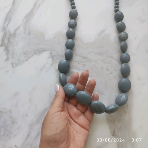 Long necklace with gray celluloid beads used