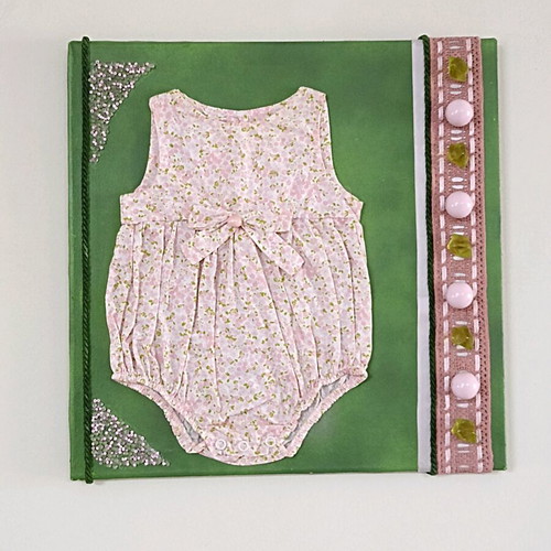 Handmade canvas frame with baby romper, pink flowers, beads, and lace