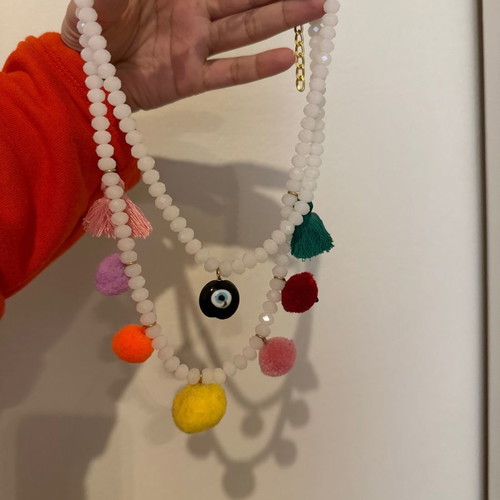 Necklace with white stones, evil eye, pom poms and tassels used