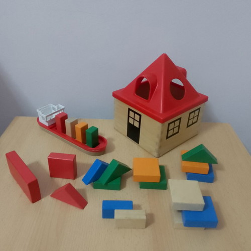 Wooden toys used with house, boat, and shapes