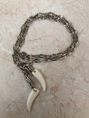 Necklace with plastic and metal fangs