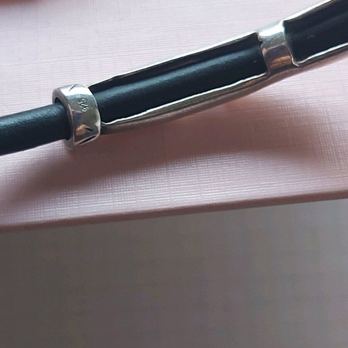 Silver bracelet used with rubber and geometric designs