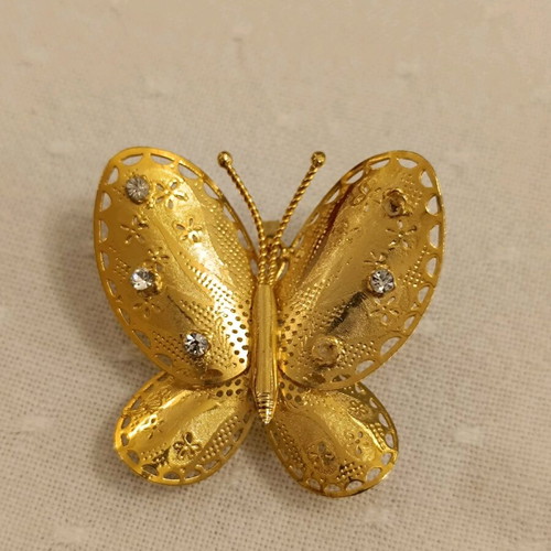 Metal butterfly brooch with rhinestones