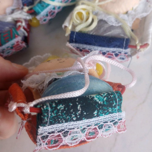 Seven cloth baby dolls in cradle new