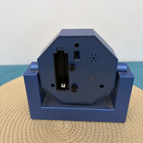 Blue analog table clock used, missing battery cover