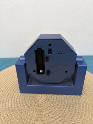 Blue analog table clock used, missing battery cover
