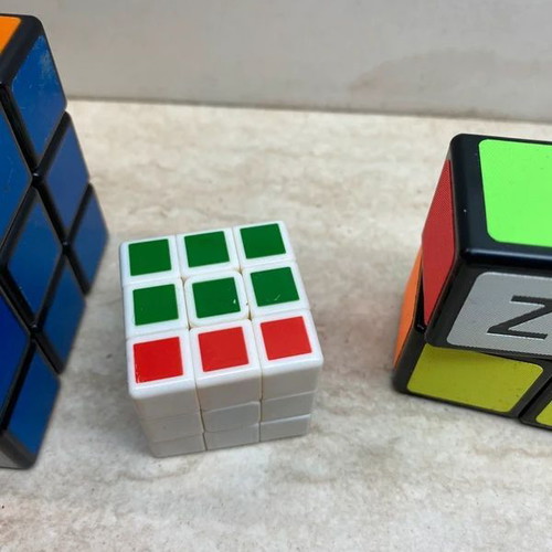 Set of 4 cubes like new, including 3x3, 3x3 mini, and 2x1