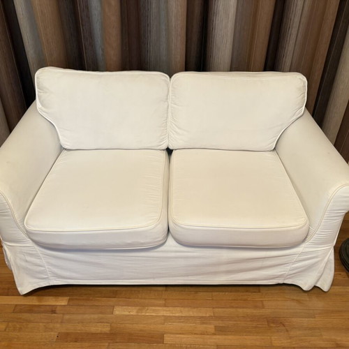 Two-seater sofa with white fabric cover like new