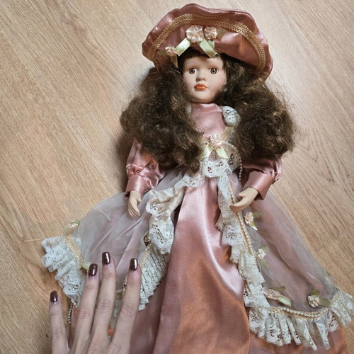 Glass doll like new with satin rotten apple dress and hat