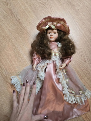 Glass doll like new with satin rotten apple dress and hat