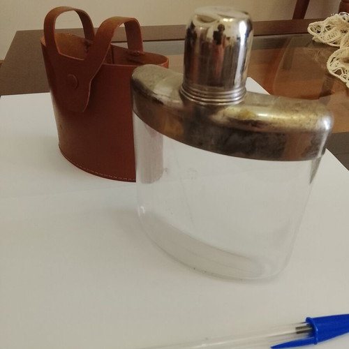 Vintage glass and metal pocket flask for alcohol in leather case used