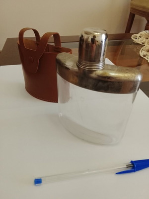 Vintage glass and metal pocket flask for alcohol in leather case used