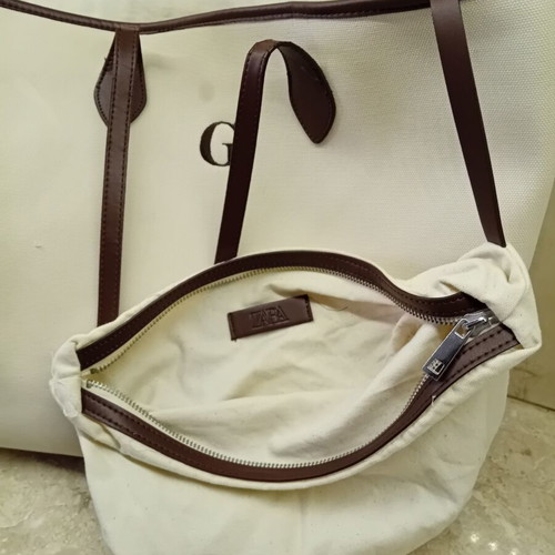 Large beige fabric shoulder bag with brown leather details