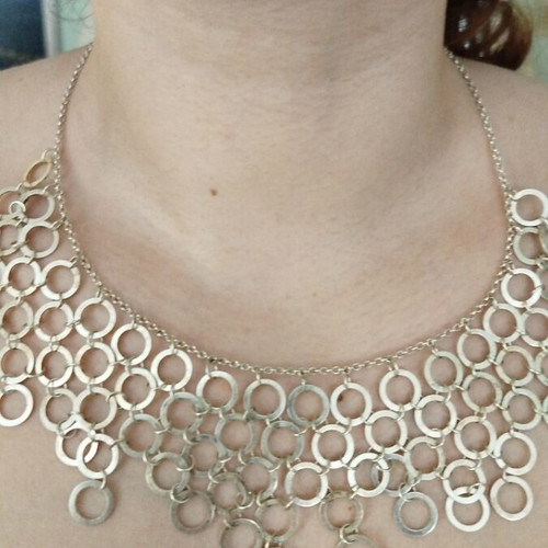 Necklace with multiple rows of interconnected silver rings like new