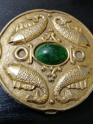 Vintage powder compact used with mirror and gold-plated box with emerald