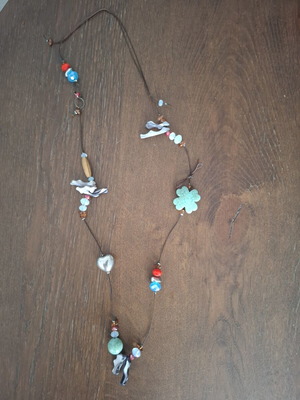 Handmade necklace with stones on dark brown cord, used