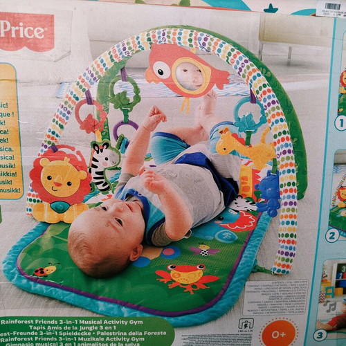Fisher Price colorful activity gym for newborns used with extra toys