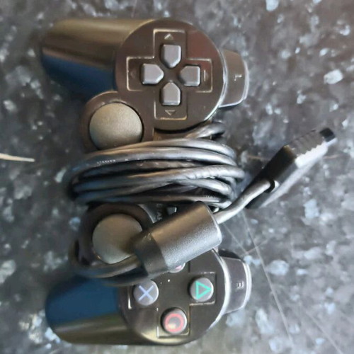 Sony PlayStation 2 console used with Thrustmaster racing wheel and accessories
