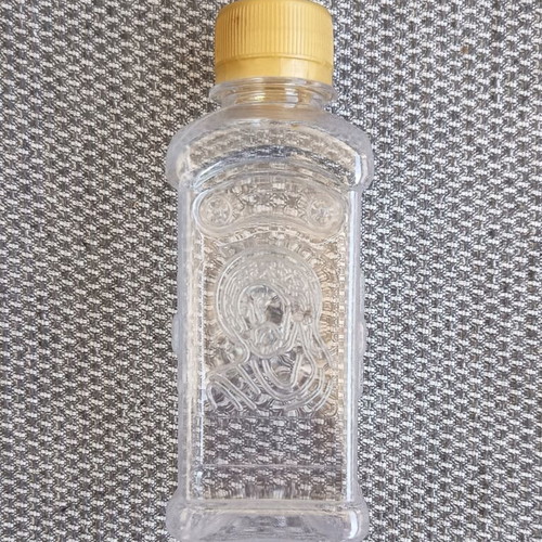 Holy water bottle like new with Christ and Virgin Mary figures