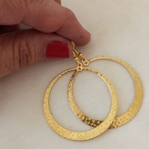 Large gold-tone hoop earrings with embossed hammered surface