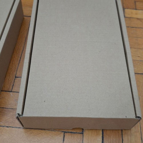 Four courier shipping boxes, kraft cardboard